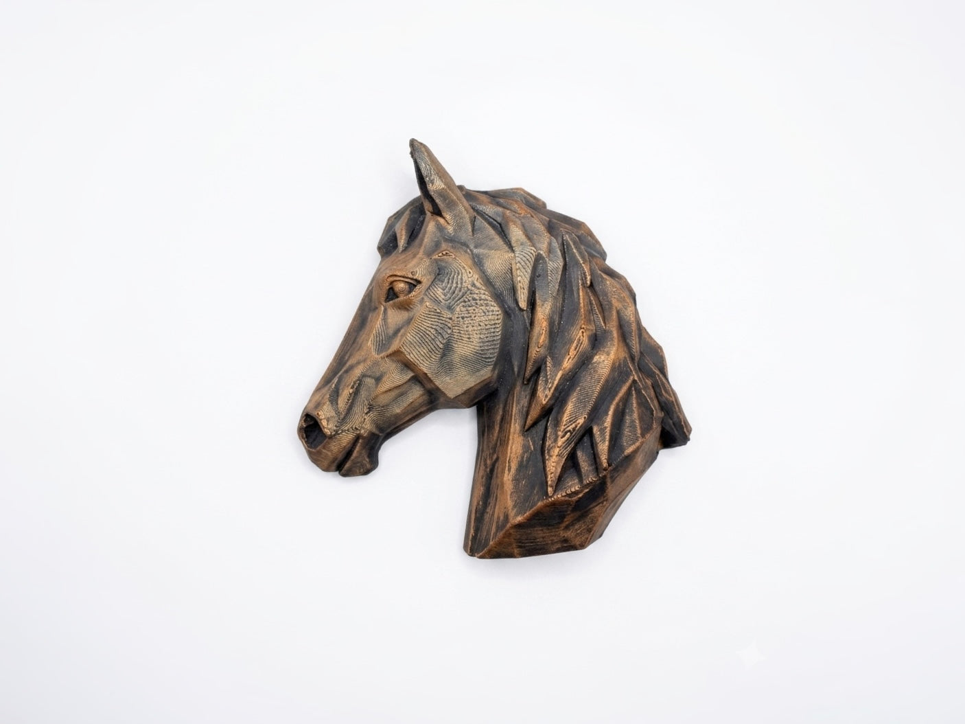 Bronze-finish geometric horse head magnet on a white background.